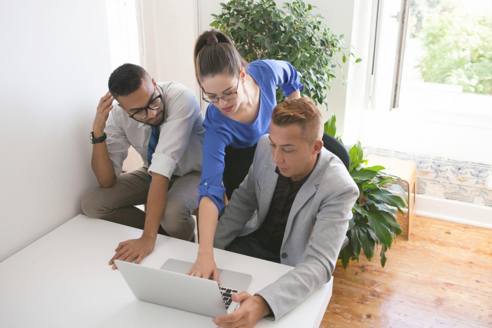 Modern web development workspace with multiple monitors showing code and design interfaces