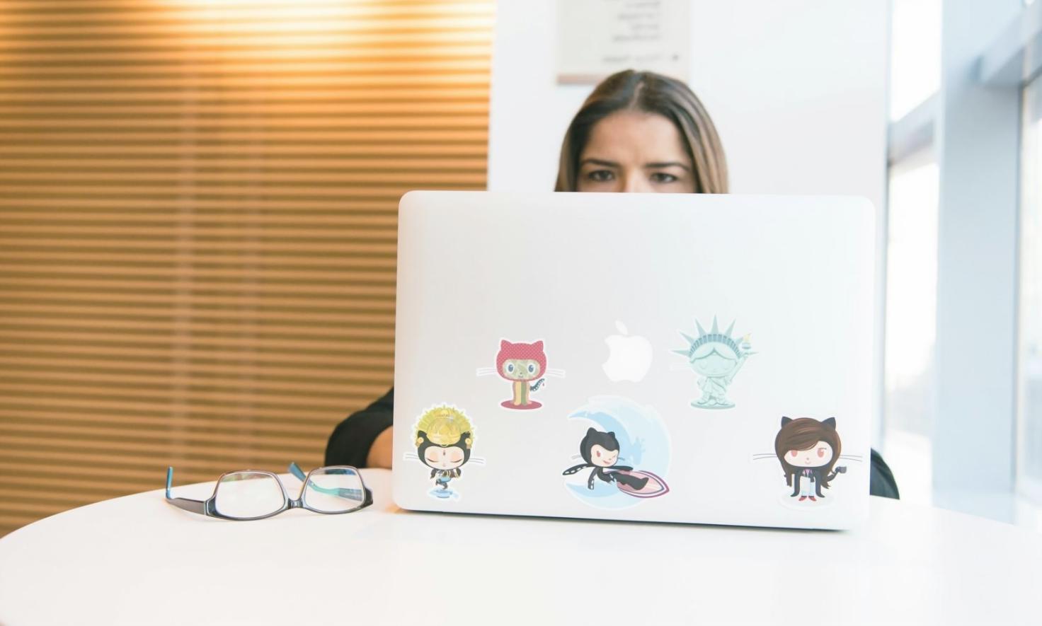 Modern classroom setup with students collaborating on web design assignments