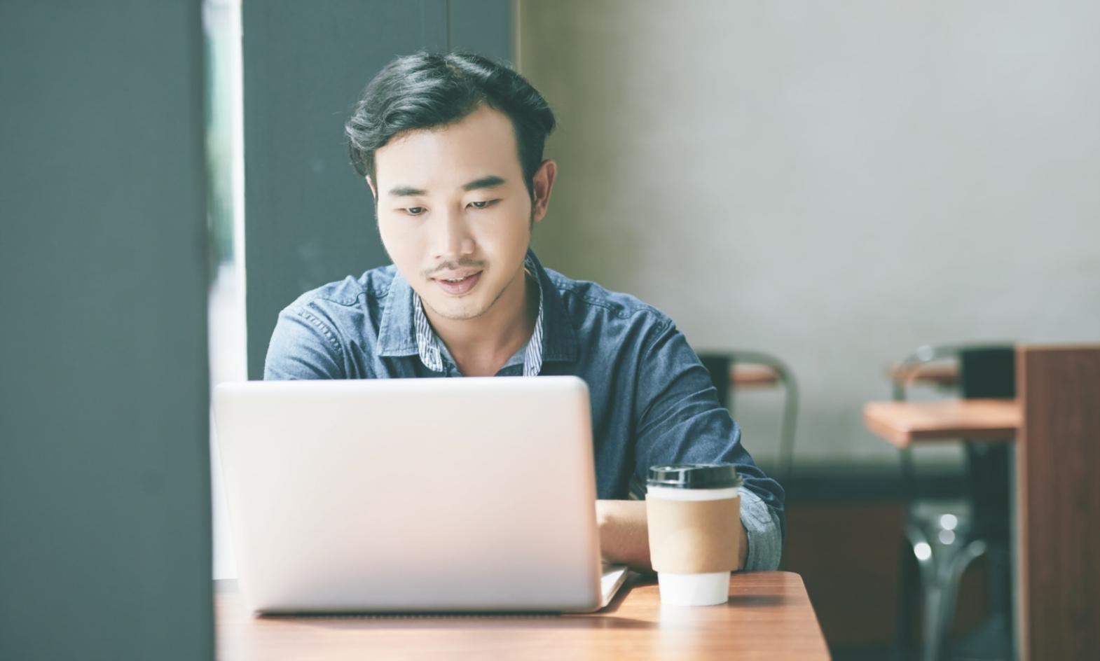 Small group of students collaborating on web design projects in informal learning environment